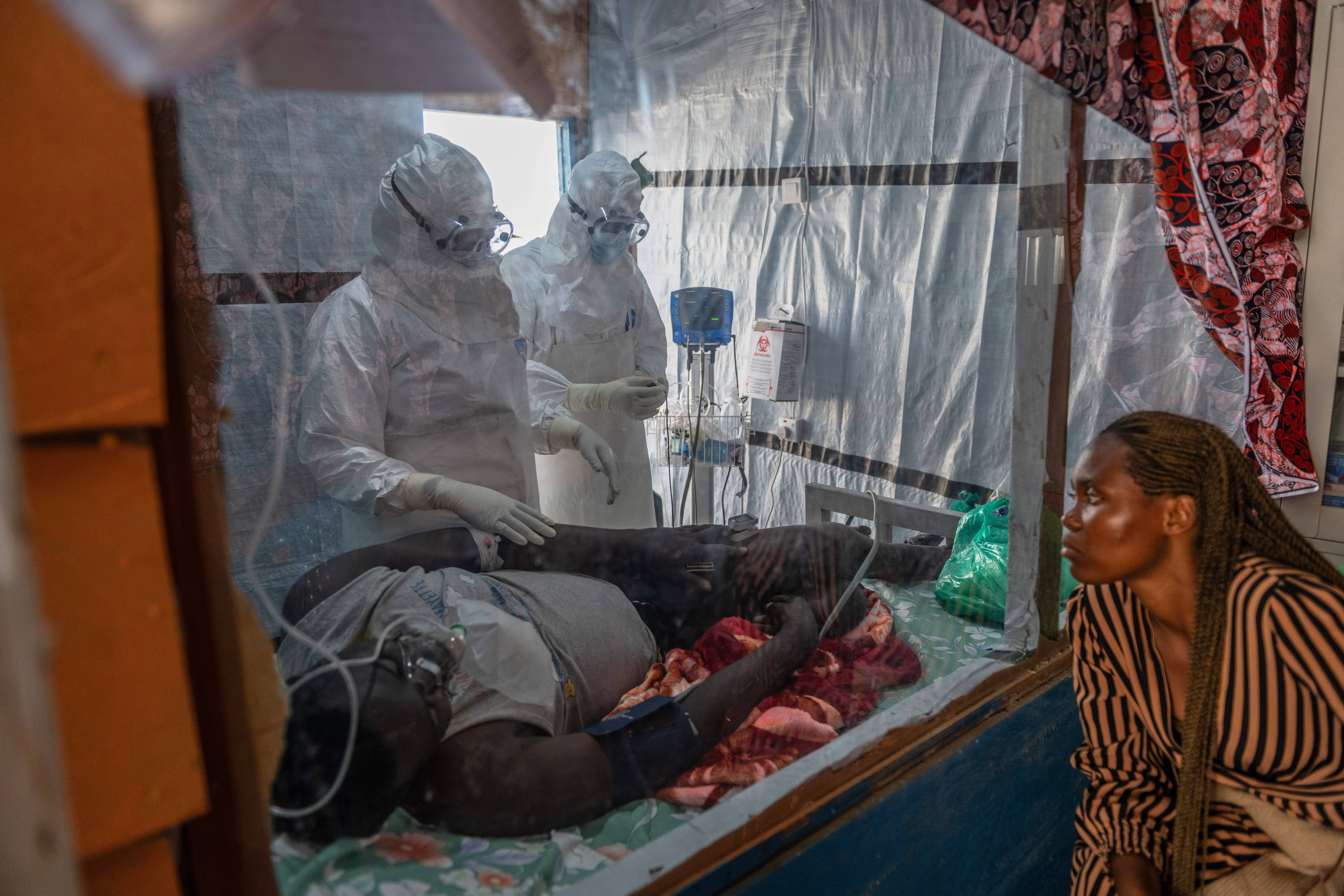 Health workers tend to an Ebola patient at the Rwampara Treatment Center in Ituri, Congo, Thursday, June 18, 2026.